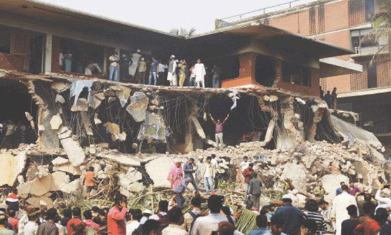 PROTESTERS look at the demolished Dhanmondi residence in Dhaka of Sheikh Mujibur Rahman, on Thursday.&mdash;Reuters