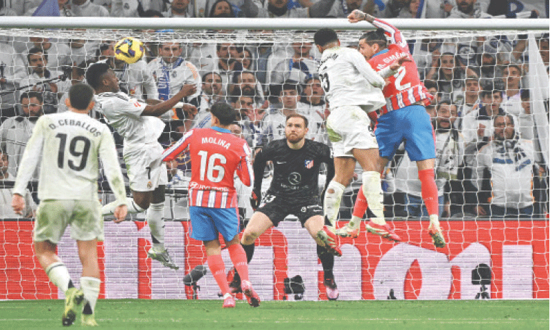 MADRID: Real Madrid&rsquo;s Jude Bellingham (second R) heads at goal during the La Liga match against Atletico Madrid at Santiago Bernabeu.&mdash;AFP