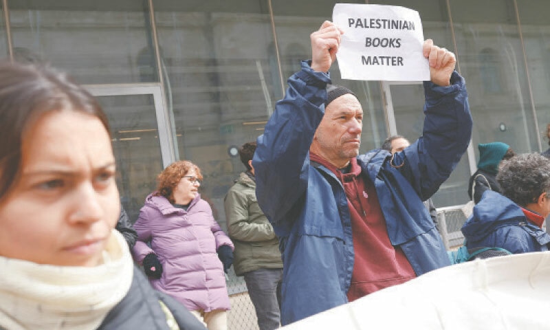 PALESTINIANS protest outside a courthouse in Israeli-occupied Jerusalem on Monday against the arrest of two booksellers.—AFP