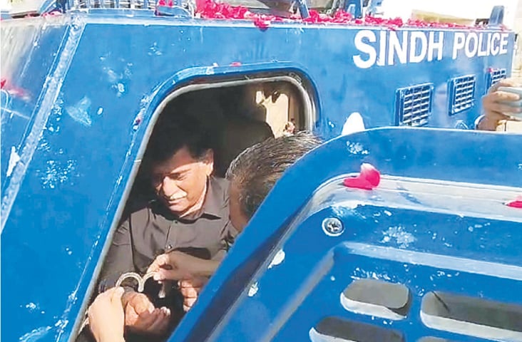 MQM-H chief Afaq Ahmed is brought to an anti-terrorism court in an armoured personnel carrier in handcuffs, on Wednesday.&mdash;PPI