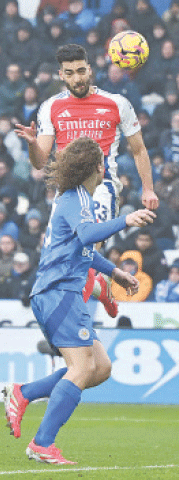 LEICESTER: Arsenal&rsquo;s Mikel Merino (top) heads to score during the Premier League match against Leicester City 
at the King Power Stadium on Saturday.&mdash;AFP