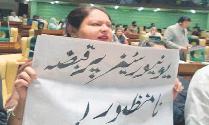 An opposition MPA protests against a law that allows non-PhD bureaucrats to become vice chancellors of public sector universities, during the Sindh Assembly session on Monday.—PPI