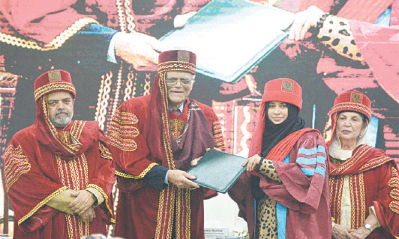 Javed Jabbar presents a merit certificate to a graduating student.&mdash;Dawn