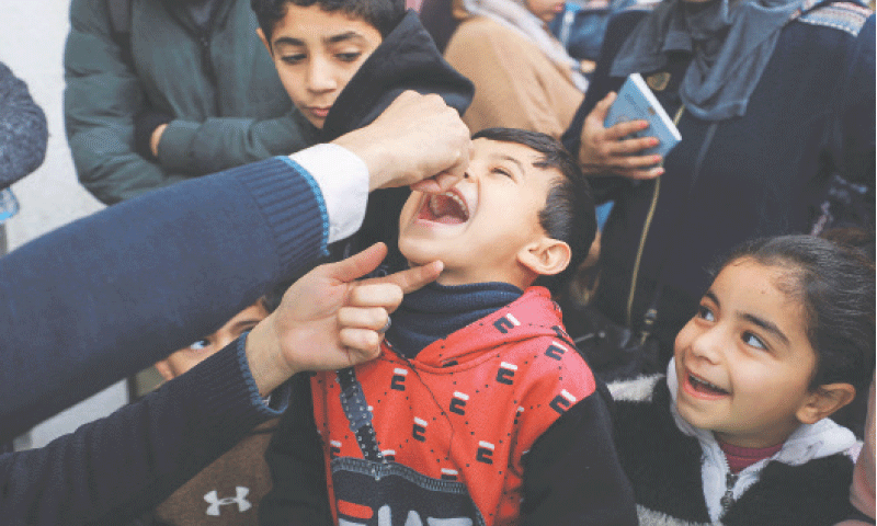 A Palestinian boy is being vaccinated against polio in Gaza City, on Saturday.—Reuters