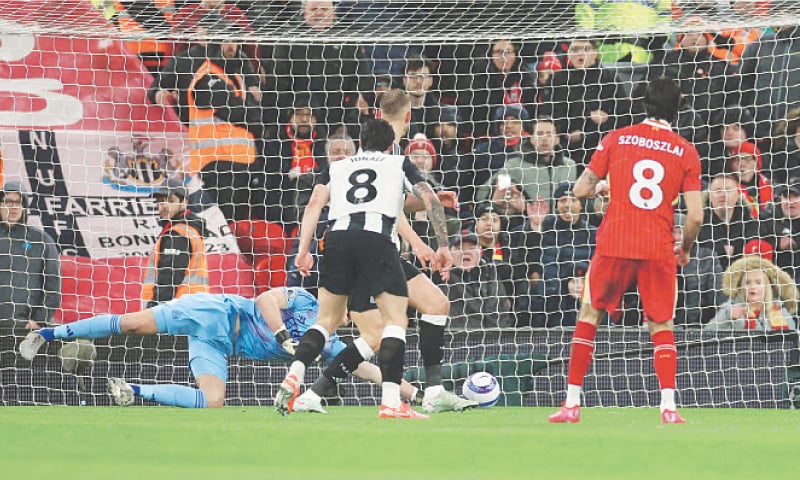 LIVERPOOL: Dominik Szoboszlai (R) of Liverpool scores past Newcastle United goalkeeper Nick Pope during their Premier League match at Anfield.&mdash;Reuters