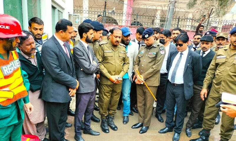 District police officials stand at the scene of an ‘honour’ Killing at the Sahiwal District Court on March 1. — Shafiq Butt