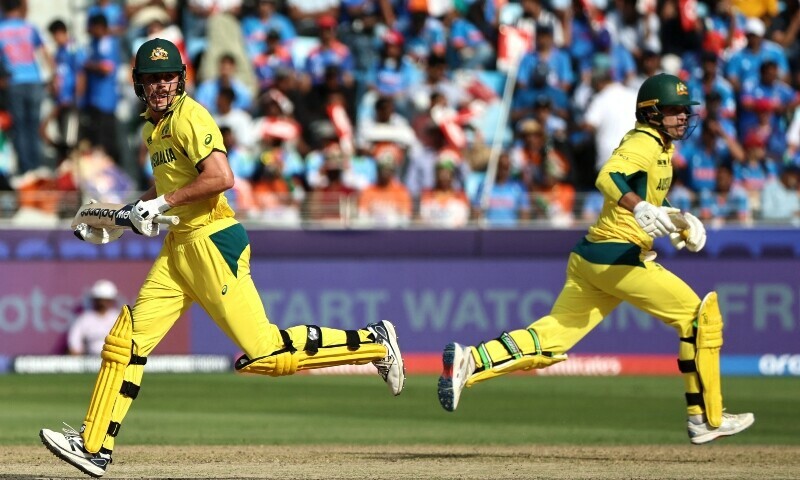 Australia’s Ben Dwarshuis (L) and Alex Carey run between the wickets during the ICC Champions Trophy one-day international (ODI) semi-final cricket match between Australia and India at the Dubai International Stadium in Dubai on March 4. — AFP