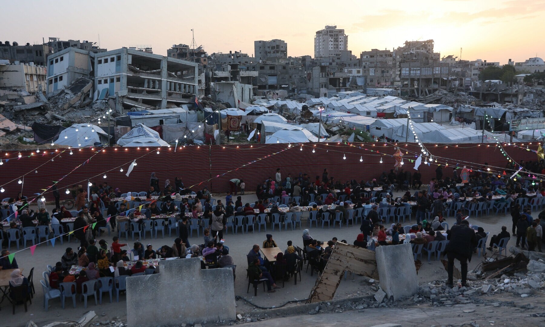  Palestinians gather for a group Iftar meal, the evening meal with which Muslims end their daily fast at sunset, in Gaza City on March 6, 2025. &mdash; AFP 