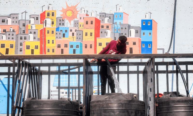 A man fills up a cistern on the back of a truck with water at the Southern Gaza Desalination plant, which stopped working earlier after Israel cut off electricity supply to the Gaza Strip, in Deir el-Balah, Gaza on March 10, 2025 . — AFP