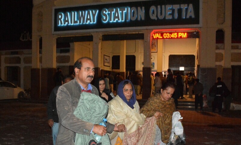 Passengers who were rescued from Jaffar Express train after it was attacked by terrorists, walk with their belongings at the Railway Station in Quetta, March 12, 2025. — Reuters/File