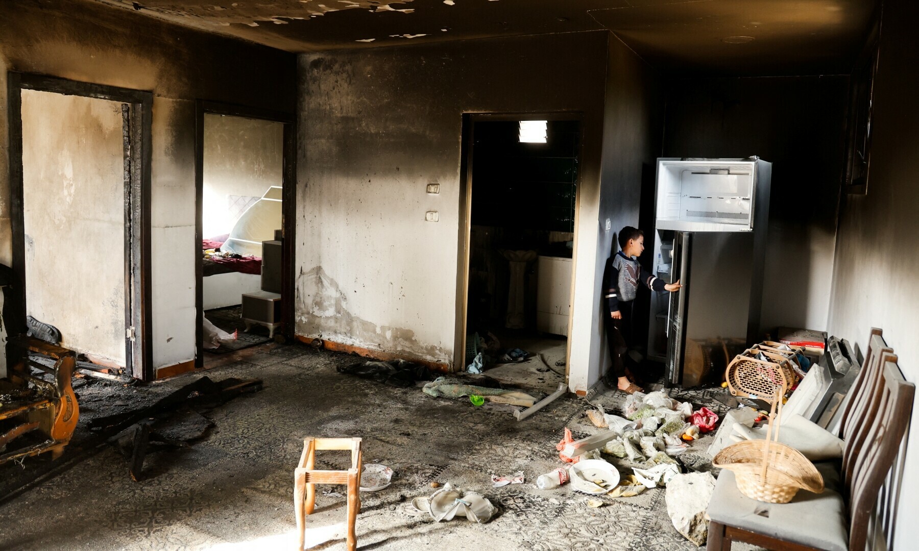A Palestinian child stands in a damaged room, following an Israeli settlers’ attack, near Duma in Nablus, in the Israel-occupied West Bank on March 14, 2025. — Reuters/Raneen Sawafta