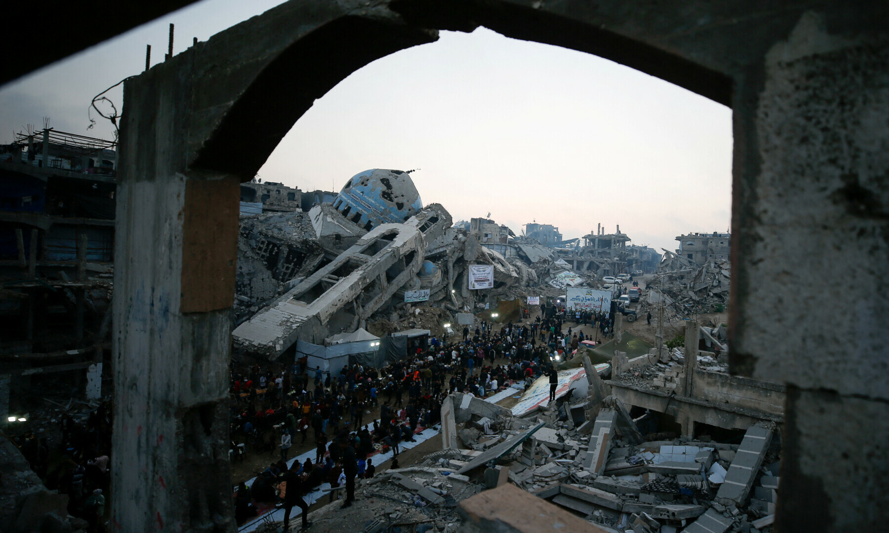  Palestinians gather to break their fast by eating Iftar meals during Ramazan, amid the rubble of buildings, in the northern Gaza Strip on March 15, 2025. &mdash; Reuters/Mahmoud Issa 