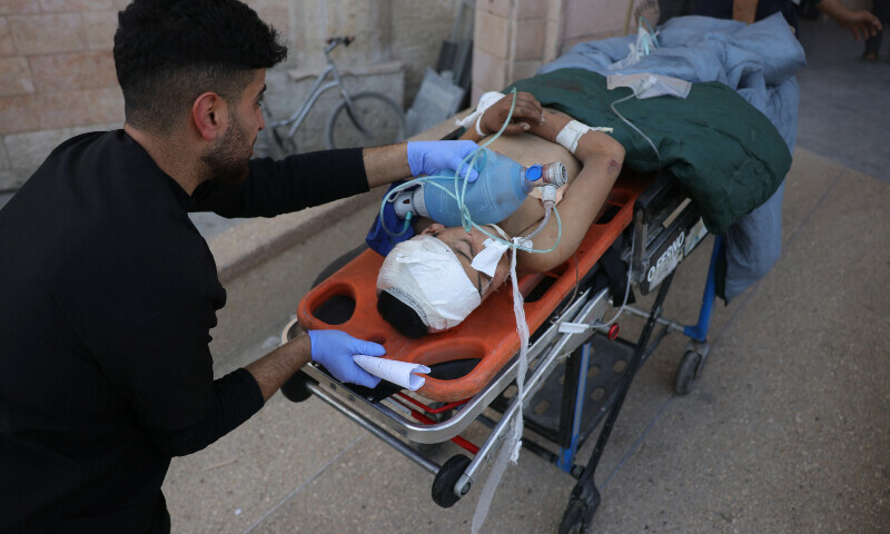 A Palestinian youth wounded in an Israeli strike is wheeled out of the emergency ward following first aid treatment at the Indonesian Hospital in Beit Lahia in the northern Gaza Strip on March 18. — AFP