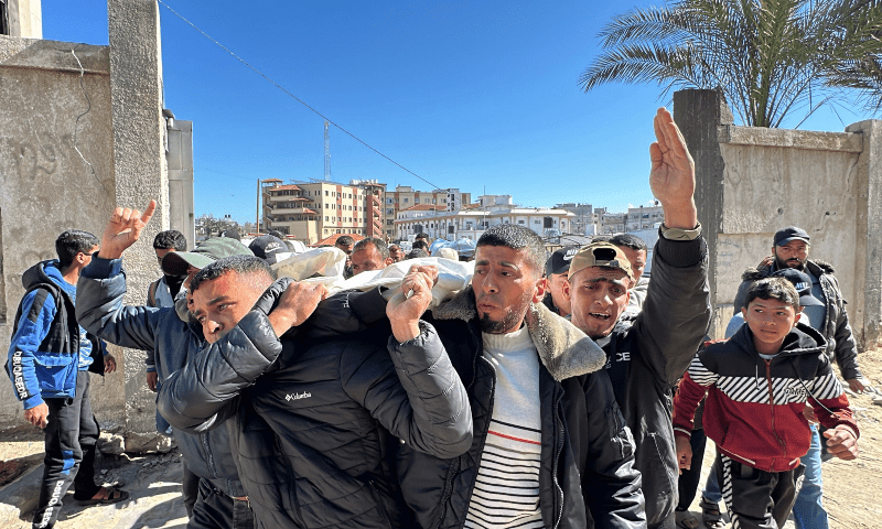  Palestinians carry the body of a relative, killed in Israeli strikes, during their funeral in Khan Younis in the southern Gaza Strip on March 23, 2025. &mdash; AFP 