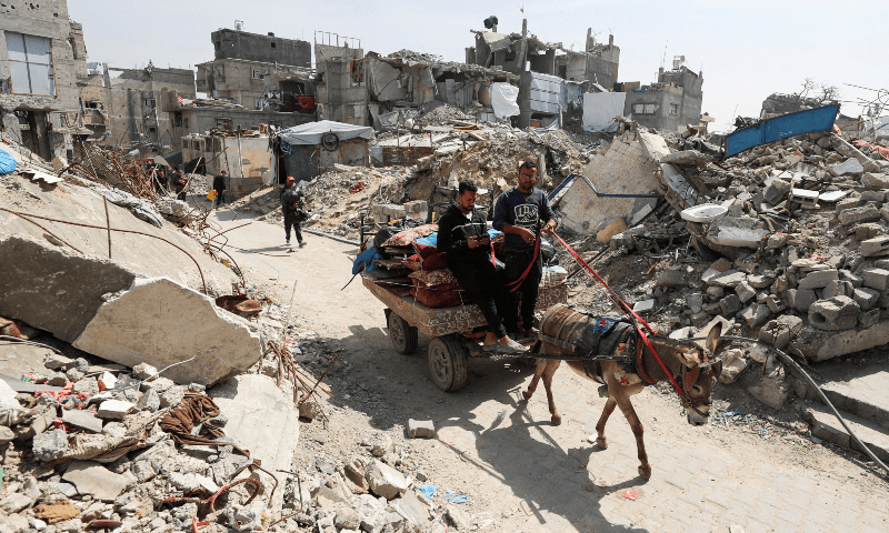Palestinians make their way as they flee their homes, after the Israeli army issued evacuation orders, in Jabalia, in the northern Gaza Strip on March 25, 2025. — Reuters