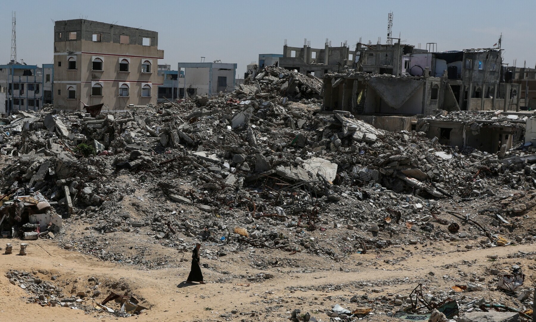 A Palestinian walks near rubble of houses in Khan Younis, in the southern Gaza Strip on March 27, 2025. — Reuters/Ramadan Abed