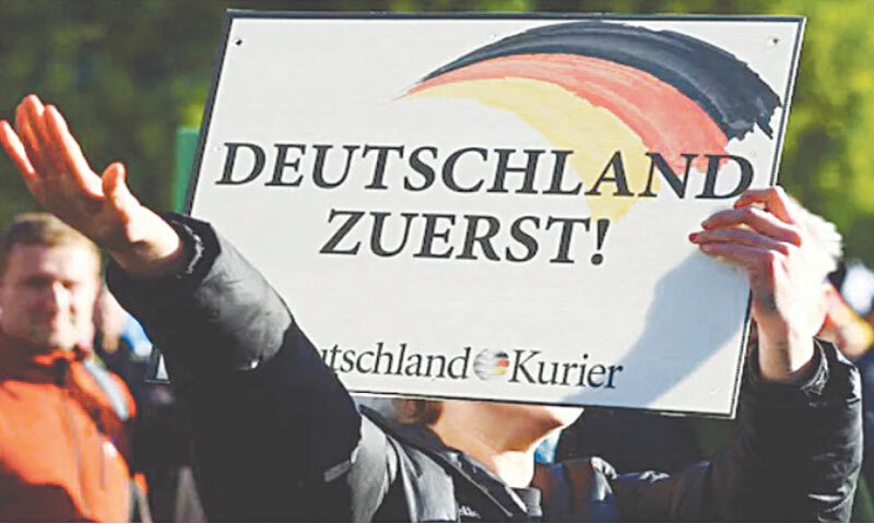 A supporter of Alternative for Germany (AfD) party does a Nazi salute during a protest against the government in Berlin, Germany, on October 8, 2022 | Reuters A supporter of Alternative for Germany (AfD) party does a Nazi salute during a protest against the government in Berlin, Germany, on October 8, 2022 | Reuters