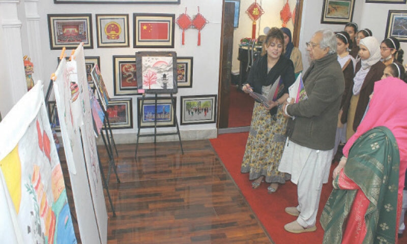 People show interest in calligraphic works and paintings at the China Window cultural centre in Peshawar. &mdash; White Star