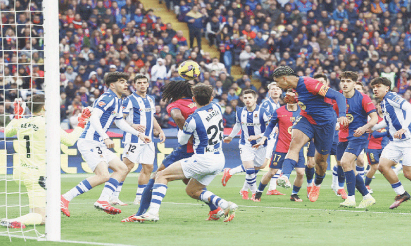 BARCELONA: Ronald Araujo (C) of Barcelona heads to score against Real Sociedad during their La Liga match at Estadi Olimpic Lluis Companys.—Reuters