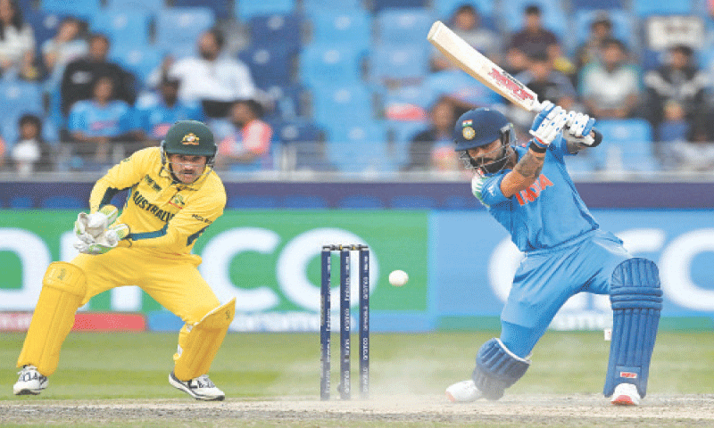 INDIAN batter Virat Kohli plays a shot as Australian wicket-keeper Josh Inglis looks on during their Champions Trophy semi-final at the Dubai International Stadium on Tuesday.&mdash;AFP
