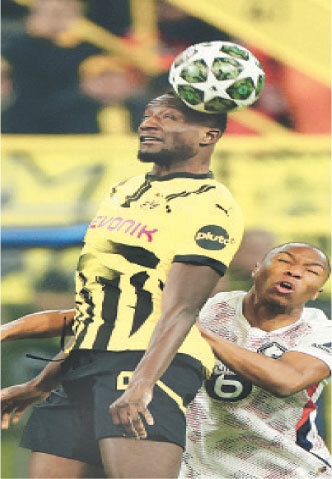 DORTMUND: Serhou Guirassy (L) of Borussia Dortmund vies for the ball with Lille’s Bafode Diakite during their last-16 first leg at the Signal Iduna Park.—Reuters