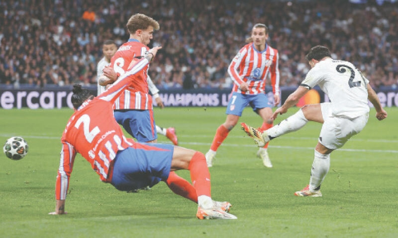 MADRID: Real Madrid’s Brahim Diaz (R) scores during the Champions League last-16 first leg against Atletico Madrid at the Santiago Bernabeu Stadium.—AFP