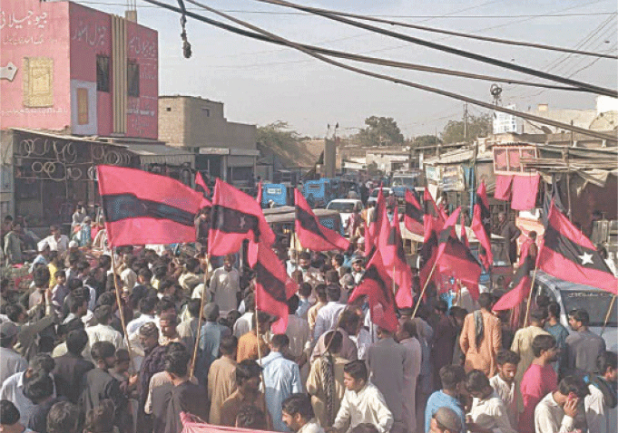  THE Awami Tehreek rally passes through a road in Karachi, on Sunday.&mdash;Dawn 