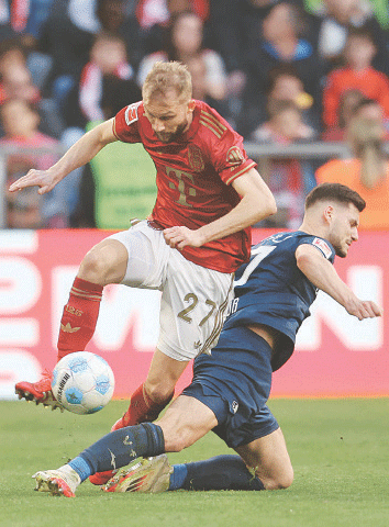 MUNICH: Konrad Laimer (L) of Bayern Munich and Bochum’s Agon Elezi vie for the ball during their Bundesliga match at Allianz Arena.—AFP