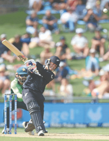 New Zealand batter Mark Chapman plays a belligerent stroke as Pakistan wicket-keeper Mohammad Rizwan looks on during the first One-day International at McLean Park on Saturday.&mdash;AFP