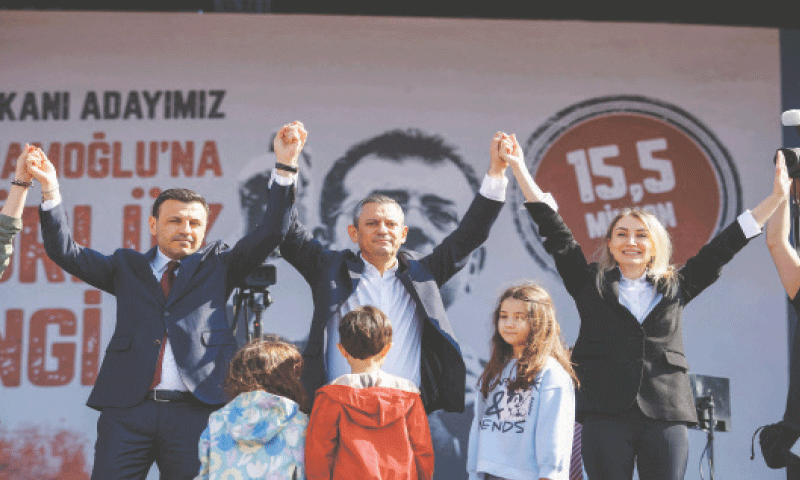 DILEK Kaya Imamoglu (right), the wife of Istanbul&rsquo;s arrested mayor Ekrem Imamoglu, holds hands with Ozgur Ozel (centre), a leader of Turkiye&rsquo;s opposition Republican Peoples Party, during a rally in Maltepe, on the outskirts of Istanbul, on Saturday.&mdash;AFP