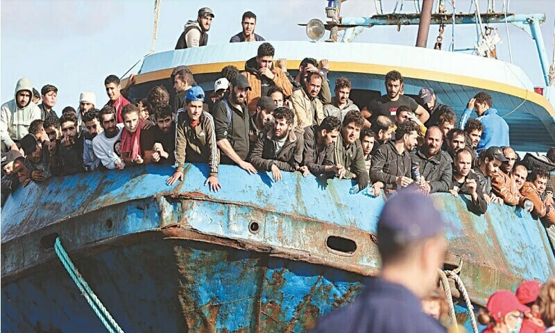 Rescued refugees and migrants stand aboard a boat at the town of Paleochora in Greece in November 2022. —AFP/File Rescued refugees and migrants stand aboard a boat at the town of Paleochora in Greece in November 2022. —AFP/File