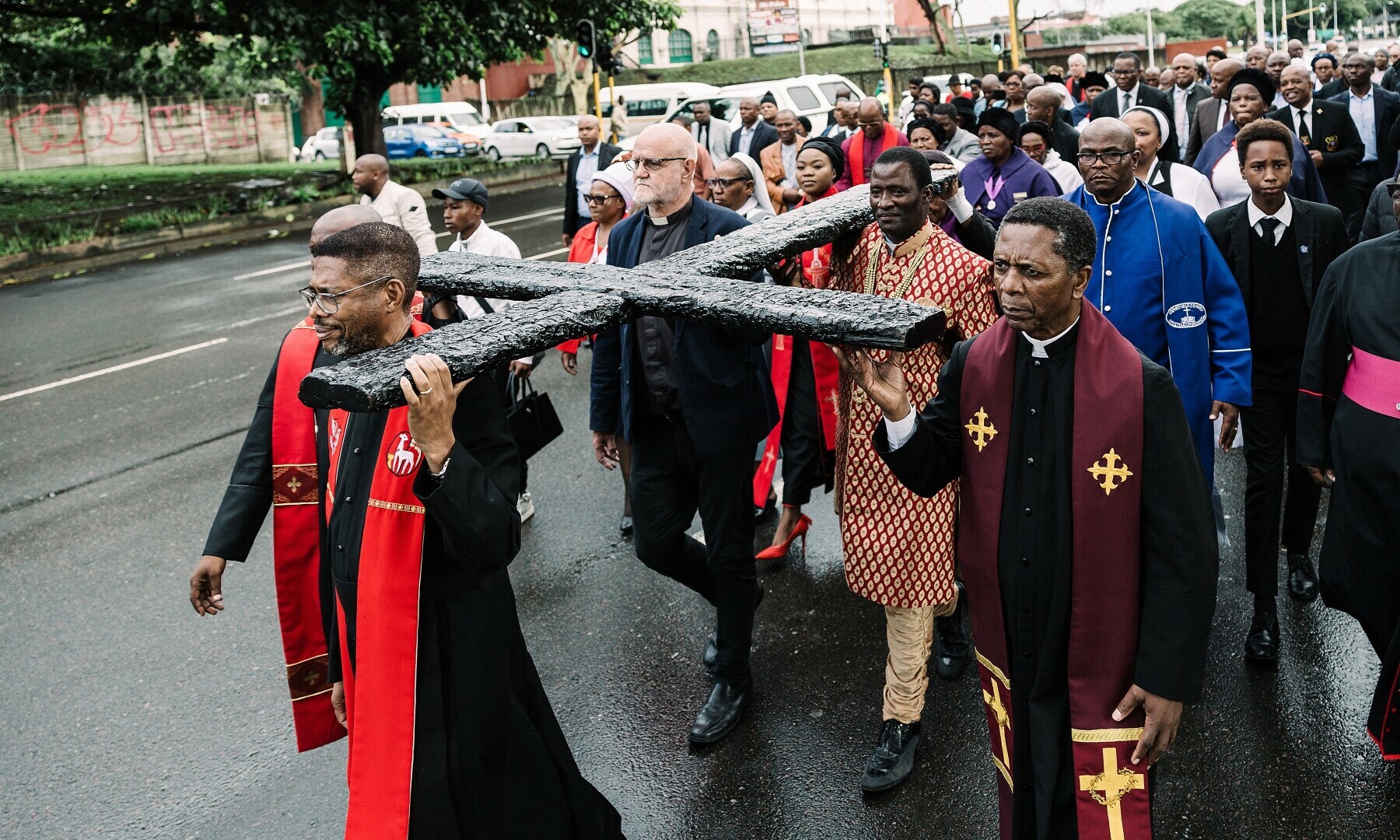  Clergymen from different denominations carry a wooden cross during a procession on Good Friday through the central streets of Durban on April 18, 2025. — AFP 