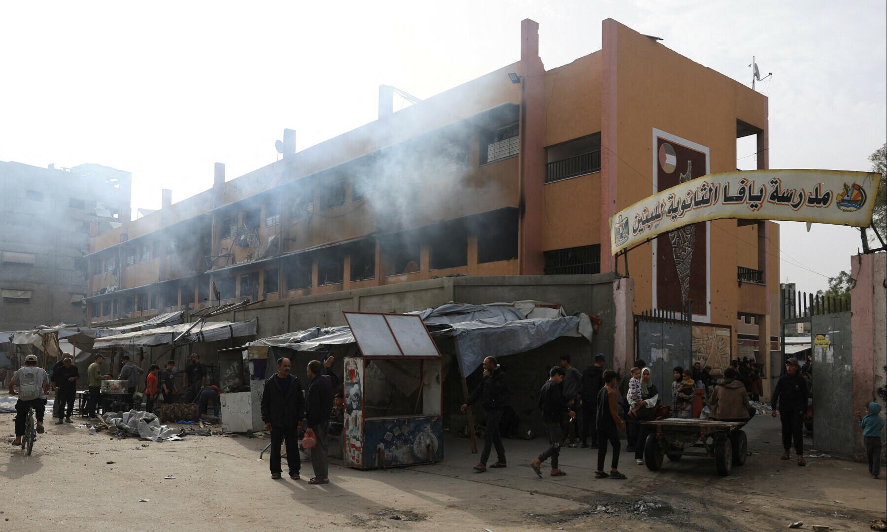 Palestinians gather outside a school sheltering displaced people, following an Israeli strike, in Gaza City on April 23, 2025. — Reuters/Dawoud Abu Alkas