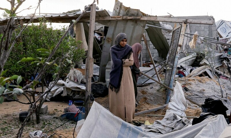 Palestinians stand at the site of an Israeli strike on a tent camp sheltering displaced people, in Khan Younis, southern Gaza Strip on April 30 — Reuters