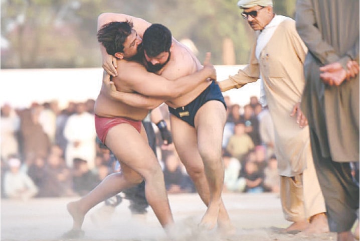 Wrestlers in action during a match. — Dawn/INP