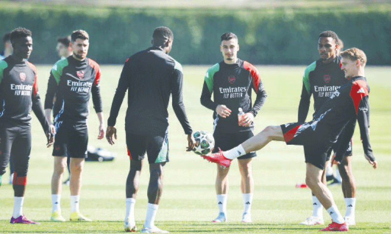 SHENLEY: Arsenal&rsquo;s Martin Odegaard (R) and team-mates take part in a practice session at the club&rsquo;s training centre on Monday.&mdash;AFP
