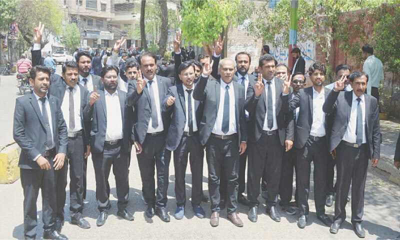 LAWYERS make victory signs during a demonstration outside Hyderabad Press Club on Wednesday.&mdash;Photo by Umair Ali