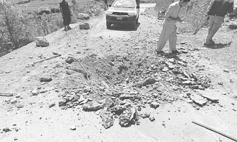 A CRATER is seen on the road after an attack near the convoy of Shangla DPO in Shekoai on Saturday.&mdash;Dawn