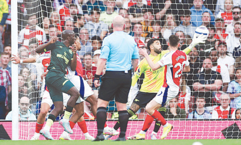 LONDON: Brentford’s Yoane Wissa (L) scores past Arsenal goalkeeper David Raya during the English Premier League match at the Emirates Stadium on Saturday.—AFP LONDON: Brentford’s Yoane Wissa (L) scores past Arsenal goalkeeper David Raya during the English Premier League match at the Emirates Stadium on Saturday.—AFP