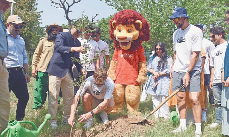Cricket players from Islamabad United plant a sapling during their visit to the Rescue and Rehabilitation Centre, formerly Marghazar Zoo, in Islamabad on Tuesday. &mdash; Online