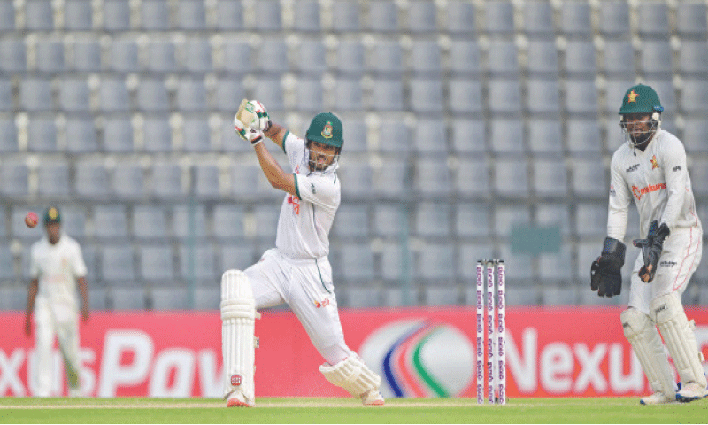 BANGLADESH captain Najmul Hossain plays a shot as Zimbabwe wicket-keeper Nyasha Mayavo looks on during the first Test at the Sylhet International Cricket Stadium on Tuesday.&mdash;AFP