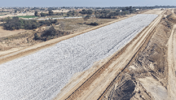 Road surface is being prepared with crush stones.
