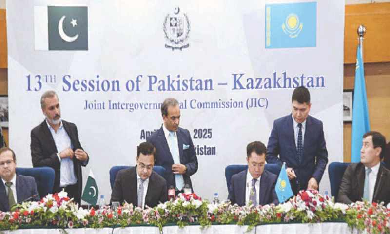 ISLAMABAD: Economic Affairs Minister Ahad Cheema and Kazakhstan’s Transport Minister Marat Karabayev sign protocols and MoUs, on Tuesday.—APP
