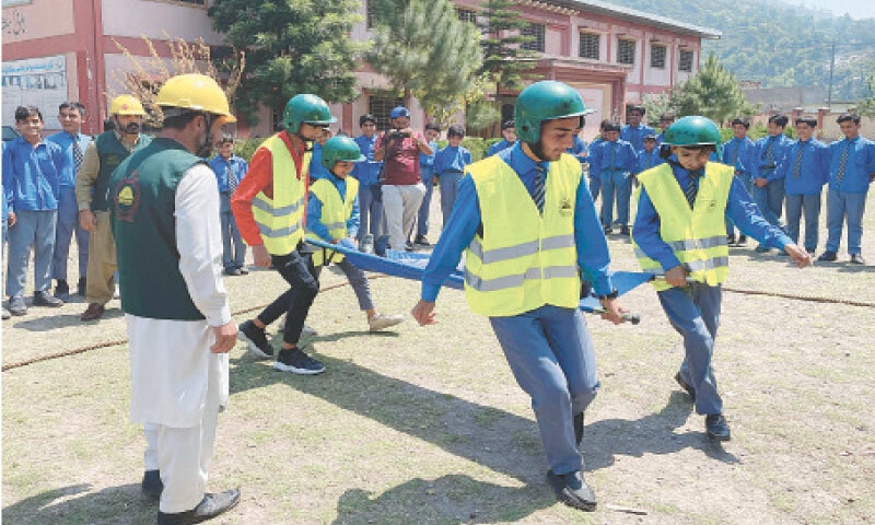 Civil Defence workers give first aid training to students at a government school in Muzaffarabad.—AFP