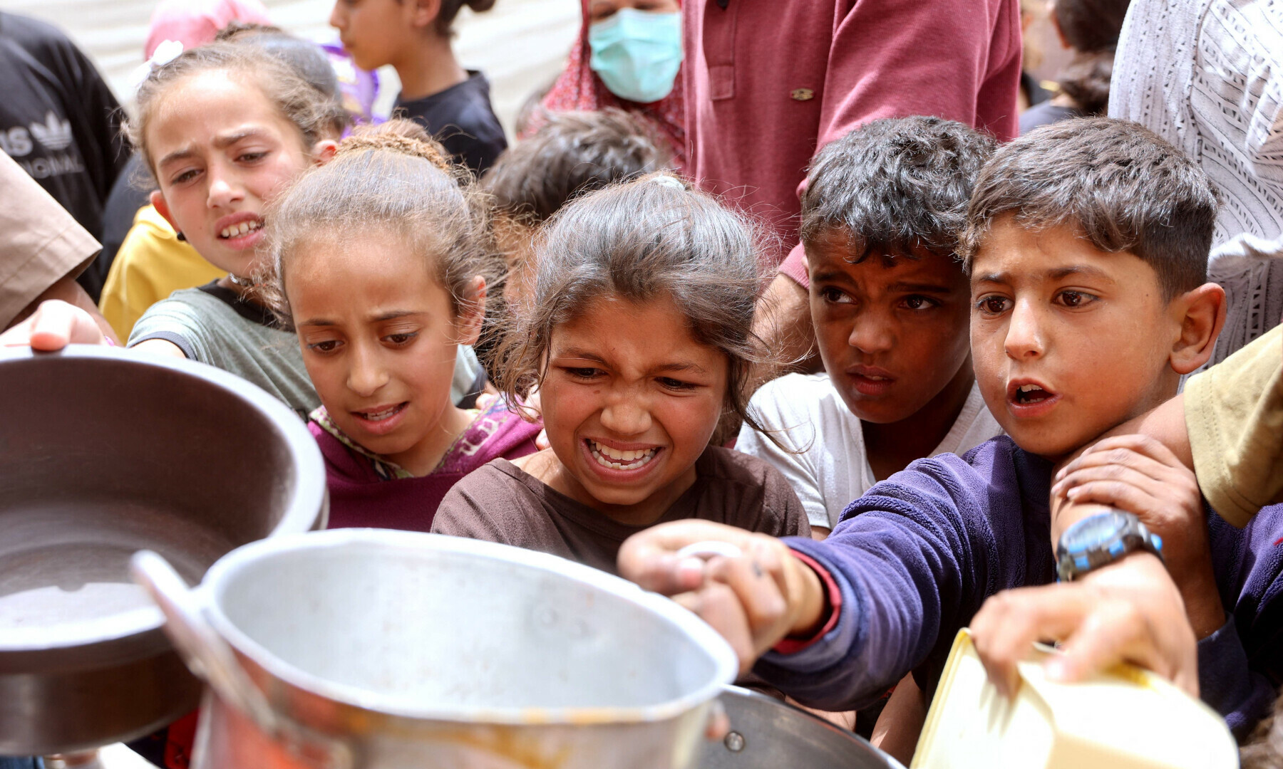  Palestinian children queue for a hot meal at a charity kitchen in Gaza City on April 30, 2025. &mdash; AFP 