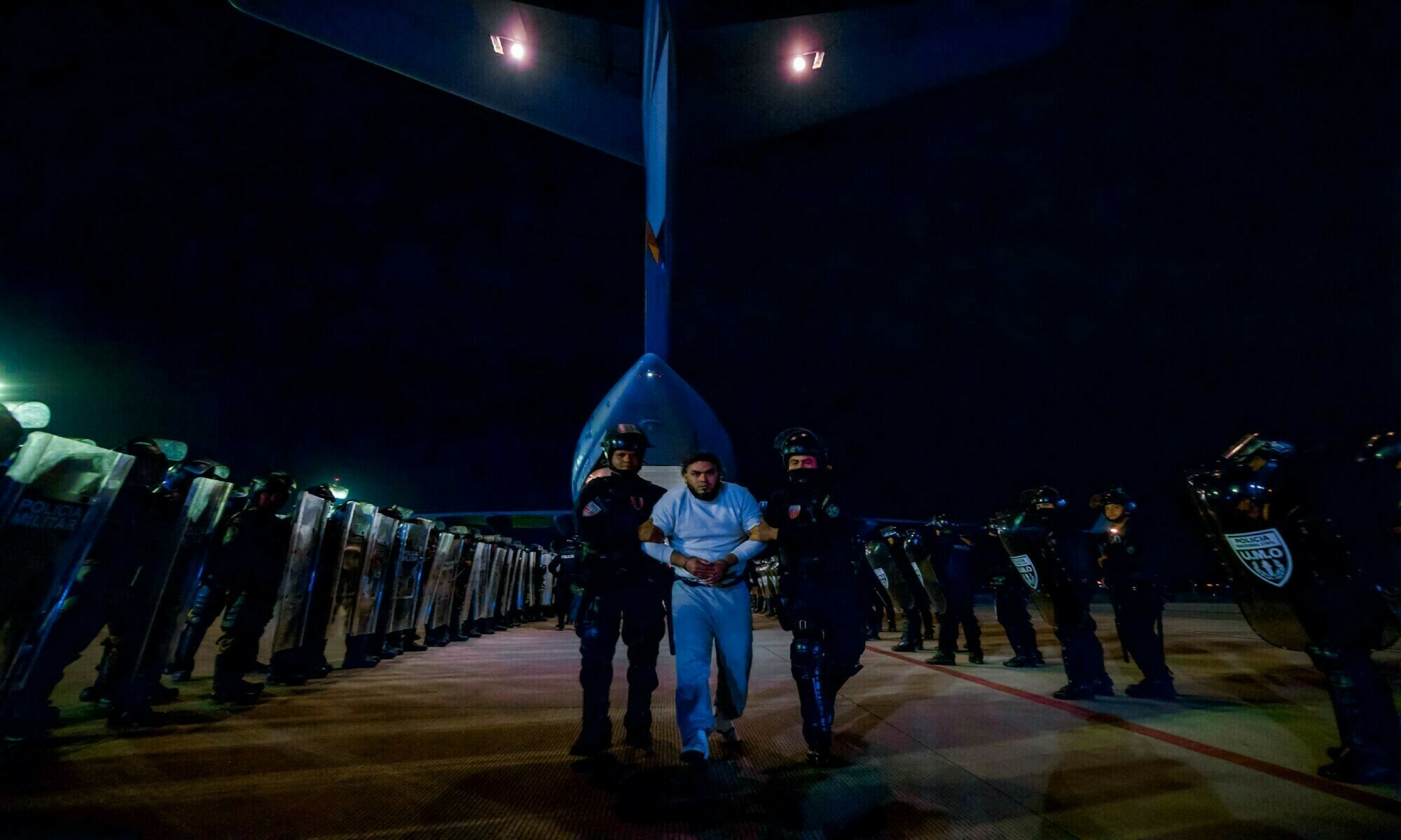 Salvadoran police officers escort alleged members of the Venezuelan gang Tren de Aragua and the MS-13 gang recently deported by the US government to be imprisoned in the Terrorism Confinement Center (Cecot) prison, as part of an agreement with the Salvadoran government, in San Luis Talpa, El Salvador, in this handout image obtained on March 31, 2025. — Secretaria de Prensa de la Presidencia/Handout — Reuters