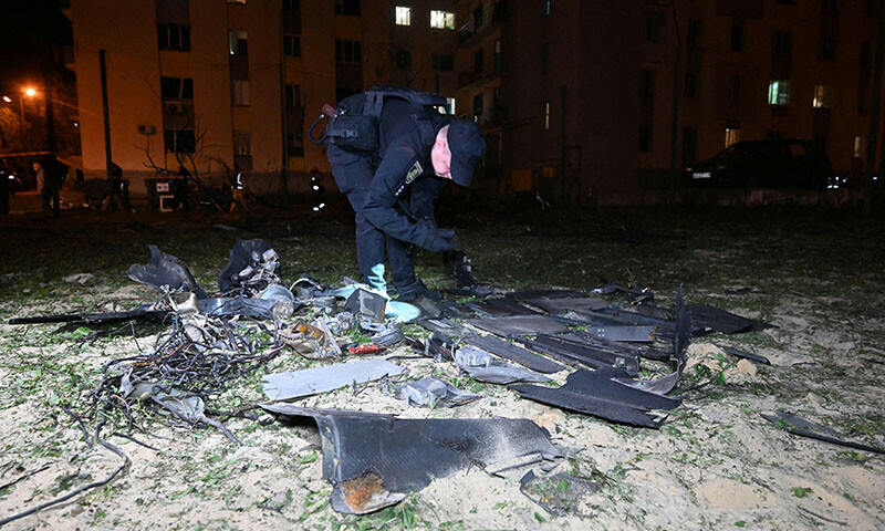 A police expert examines fragments after a drone strike in Kharkiv, Ukraine on May 3. — AFP