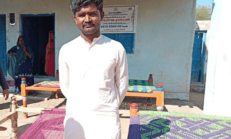  A proud Jaswant Kumar poses with his colourful charpoys. &mdash; Photo by the author 