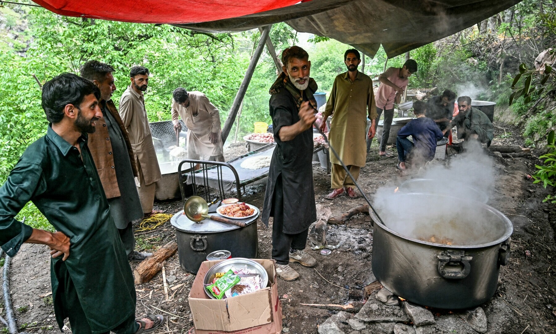 Kashmiri cooks prepare food for the wedding guests at the groom’s house in Ashkot village on the Line of Control (LoC) in Neelum Valley, a district of Azad Jammu and Kashmir, on May 3. — AFP