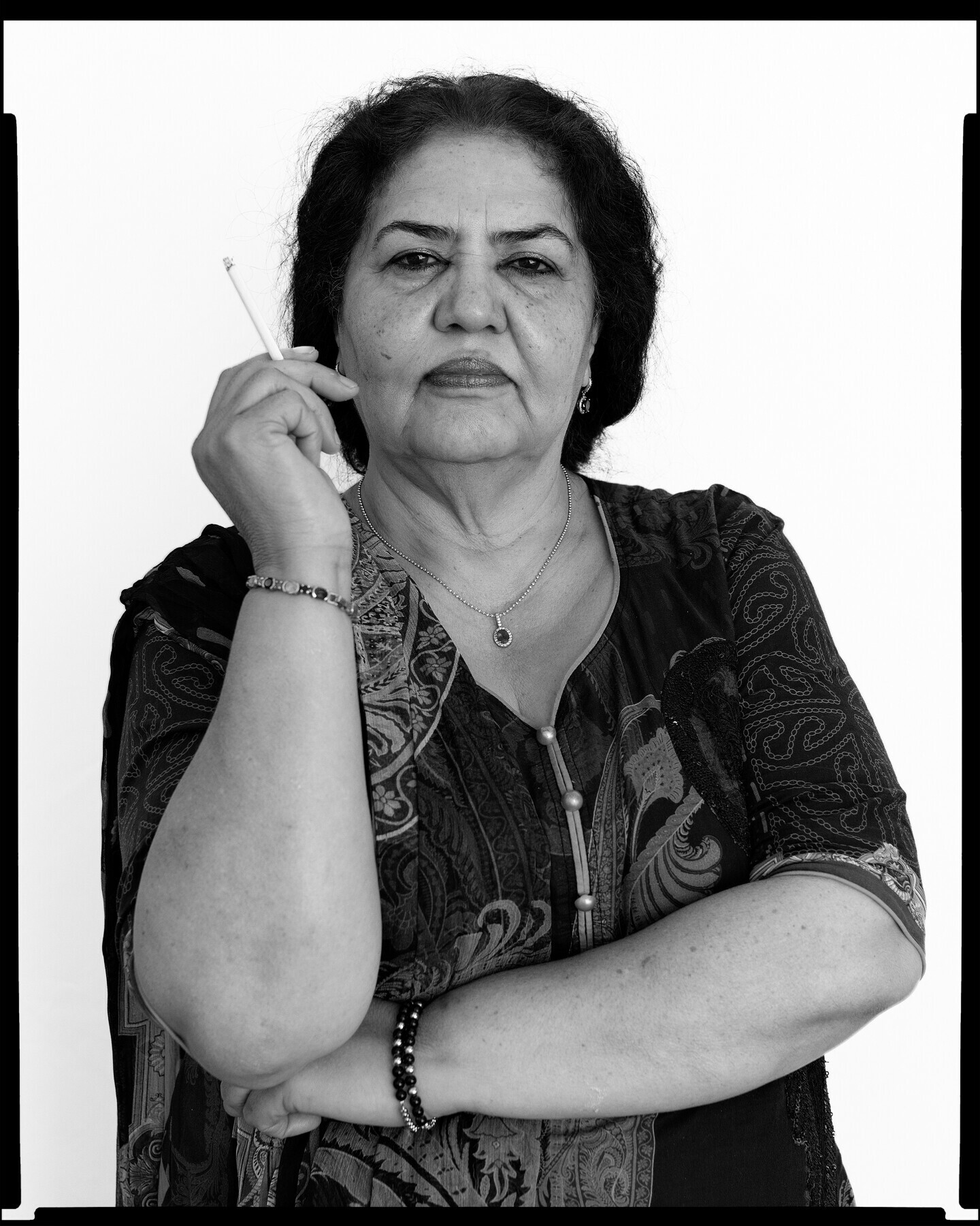  Image depicting the artist&rsquo;s mother, Imtiaz, holding a cigarette at Mahtab Hussain&rsquo;s solo exhibition. &mdash; David Rowan 
